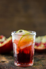 Pomegranate lemonade on black rustic metal table