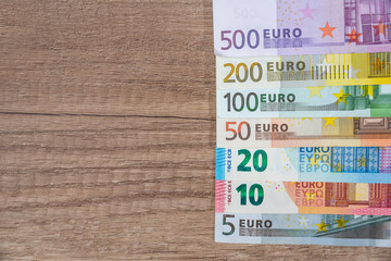 et of euro banknotes on wodden desk.