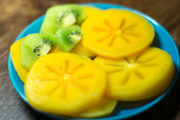 Persimmon on a blue plate
