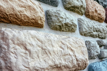 decorative wall, which is built from river pebbles and cement. Exterior view of the building