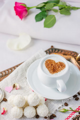 Breakfast in bed on copper tray over bed linens.