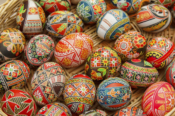 Multicolored Easter eggs in a basket closeup