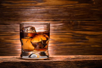 whiskey with ice on a wooden table