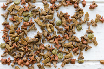 Pets food on white wooden table.