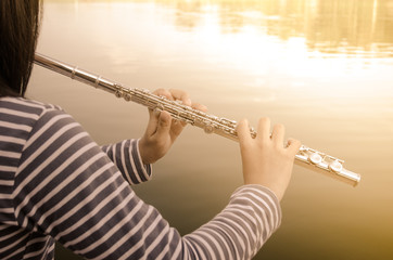 Hands of a woman playing a flute