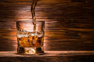 whiskey with ice on a wooden table