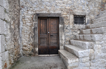 Fototapeta na wymiar Old wooden door of an ancient building