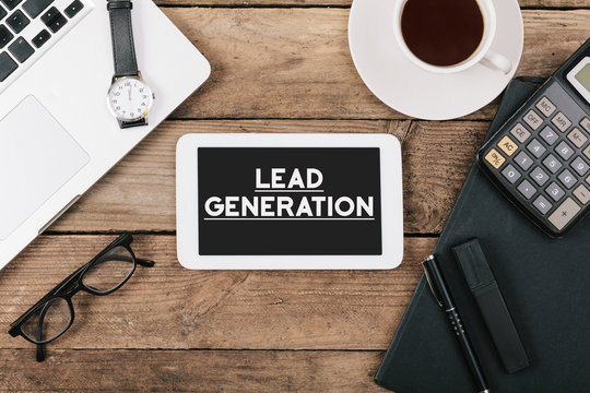 Lead generation on phone on Office desk with computer technology