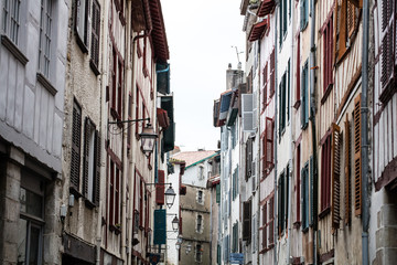 old regional beautiful street and facades with colorful wooden blinds