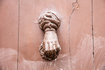 detail, old metal door knocker in shape of woman hand