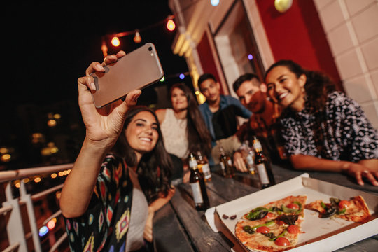 Group of friends making a selfie at rooftop party