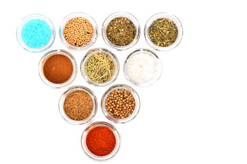 various spices in jars on white background