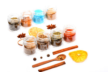 various spices in spoons, jars, dried lemon on white background