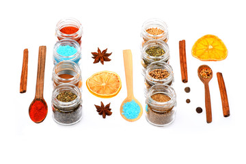 various spices in spoons, jars, dried lemon on white background