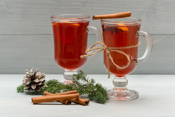 tea or mulled wine with cinnamon, fir, pinecone at christmas