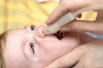 Mother using child nasal aspirato