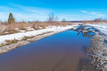 The road during the spring thaw with mud