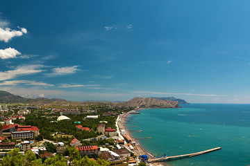 Fototapeta na wymiar Panorama of the resort town of Sudak in the Crimea. Beautiful summer marine landscape. Travel photos