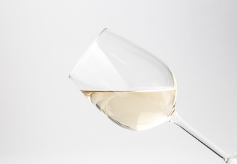 Tilted glass of white wine