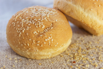 Fresh hamburger buns with sesame seeds. . Fast food.Butter cakes
