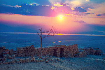 Naklejka na ściany i meble Beautiful sunrise over Masada fortress. Ruins of King Herod's palace in Judaean Desert.