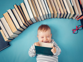 One year old baby with spectackles and books