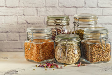 Glass jars with various legumes - beans, mung bean, peas and len