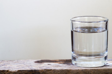 Drinking water in glass on a wooden floor.