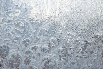 Frozen winter window. Texture ice patterns on glass. Selective focus.