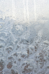 Frozen winter window. Texture ice patterns on glass. Selective focus.
