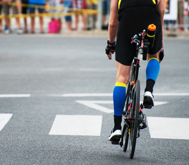 Unrecognizable professional cyclist during the bicycle competition. Back view.