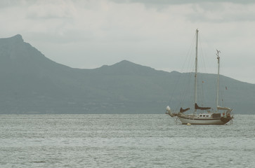 Fototapeta premium Yacht with solar panels in the bay at morning.