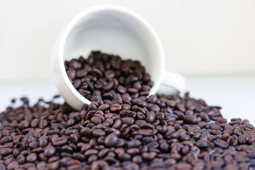 Coffee beans in coffee cup isolated on white