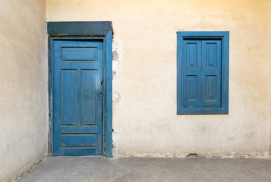 Blue wooden window and door of a old historic building with vintage plaster wall, Medieval Cairo, Egypt