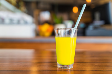 Fresh yellow juice in a glass.