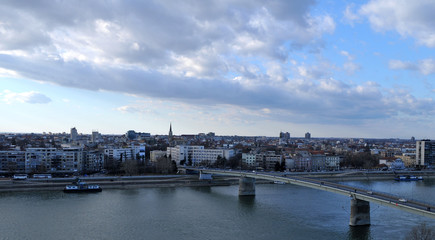 Fototapeta premium Photographed moment busy city of Novi Sad during a sunny winter day in December. With views from the Petrovaradin fortress, Serbia