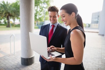 Fototapeta premium Businessman and colleague discussing over laptop 