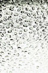 Fresh drops of water on a glass surface. Selective focus this image