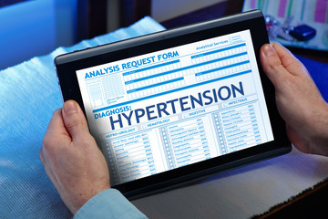 Man consulting on internet your medical record with hypertension / Patient with hypertension diagnosis fill out a report digital medical for second opinion