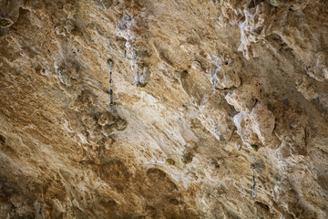 Stone surface, natural cliff with hanging quickdraws