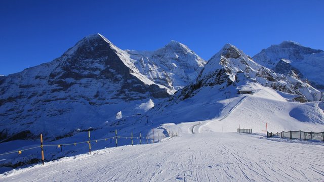 Ski slope and snow covered mountaind Eiger, Monch, Lauberhorn and Jungfrau