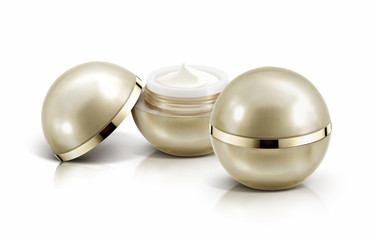 Two golden sphere cosmetic jar on white background