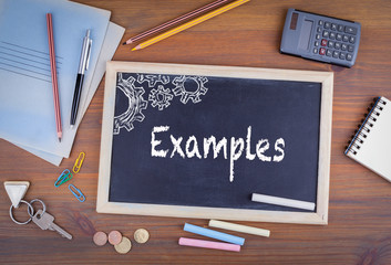 Examples. Chalkboard on wooden office desk. Untidy workplace