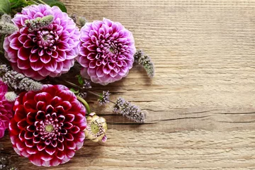 Fotobehang Dahlia flowers on wooden background © agneskantaruk