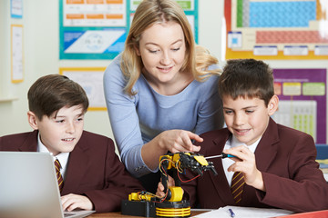 Teacher With Pupils In Science Lesson Studying Robotics