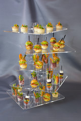 Mini desserts and meat canapes vegetable snacks in plastic cups canapes 