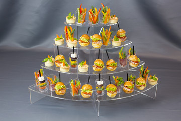 Mini desserts and meat canapes vegetable snacks in plastic cups canapes 