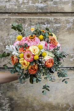 Wedding bouquet with rose, zinnia and brunia flowers.