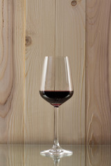 brilliant glass with red wine on a glass stand