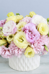 Floral arrangement with pink carnation and yellow eustoma flower
